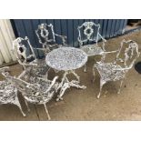 A painted cast metal circular garden table and a set of six chairs, the table 60 cm diameter