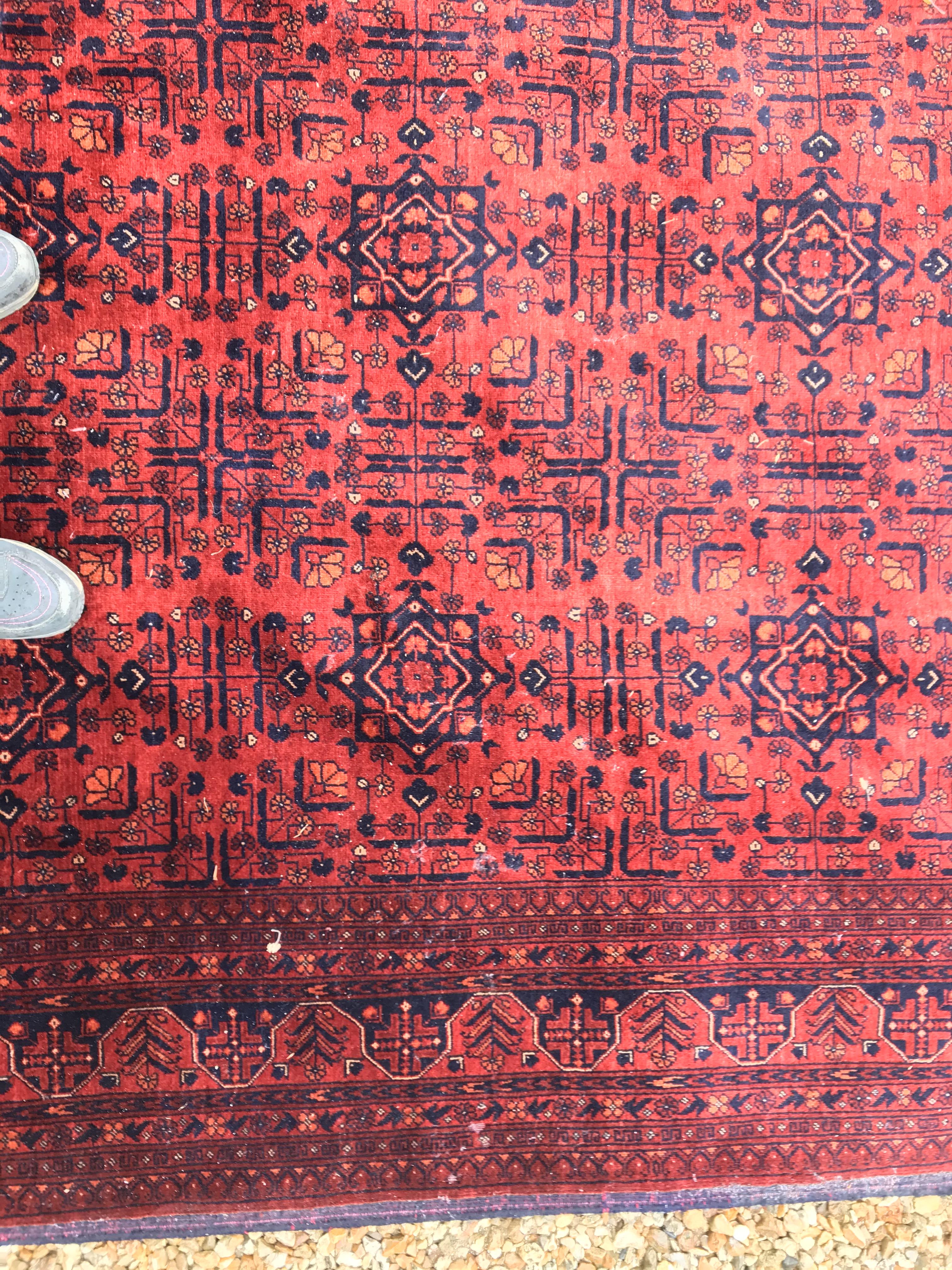 A Bokhara type carpet, the central panel set with repeating medallions on a dark red and black - Image 10 of 23