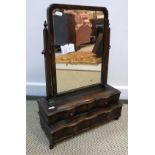 A circa 1900 walnut toilet mirror in the early Georgian manner, the plain plate over two pairs of
