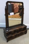 A circa 1900 walnut toilet mirror in the early Georgian manner, the plain plate over two pairs of