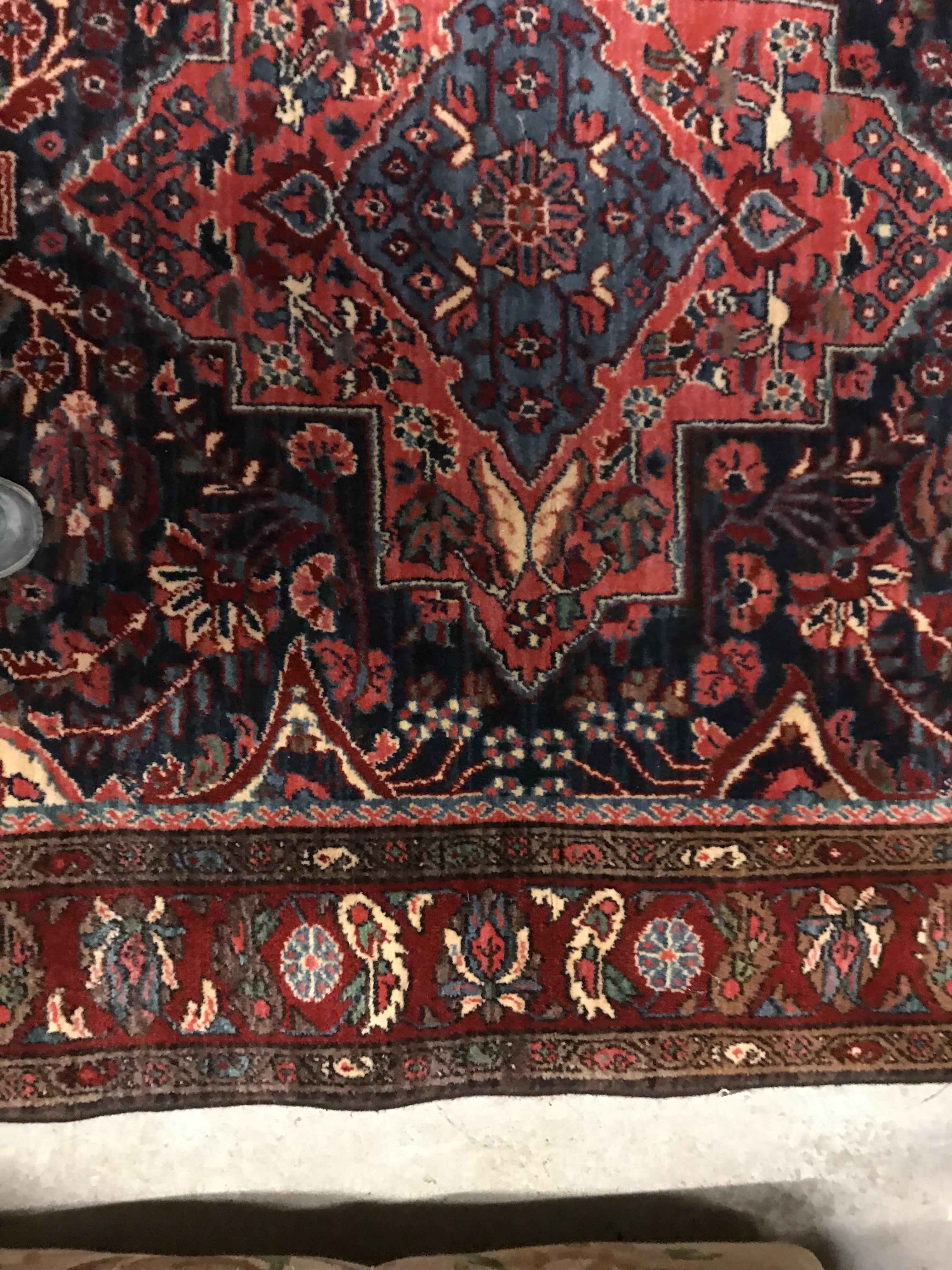 An Oriental carpet, the central panel set with foliate decorated medallion on a red and blue - Image 6 of 11