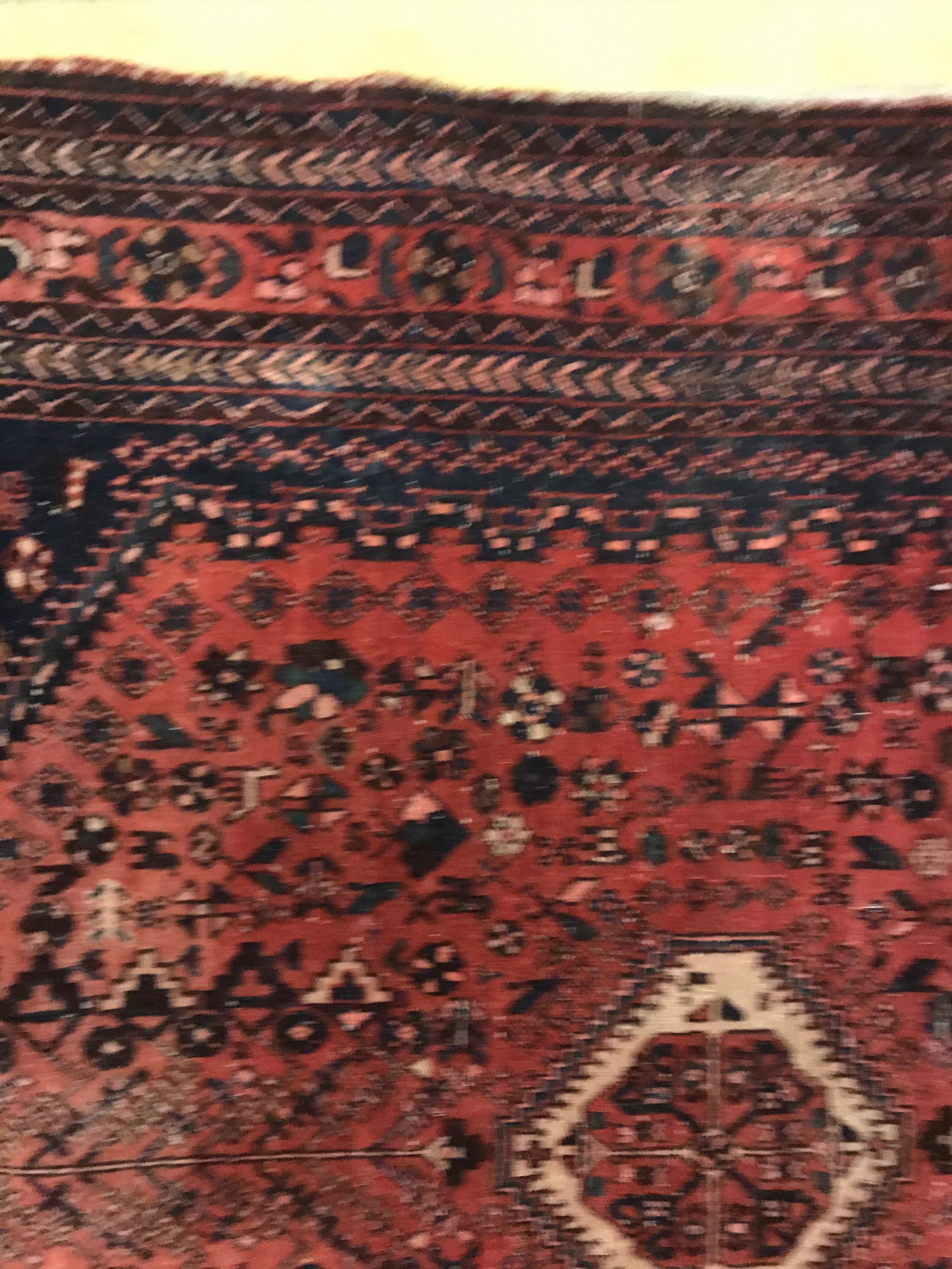 A Caucasian rug, the central panel set with three repeating medallions on a pale blue ground, within - Image 18 of 33