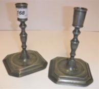 A pair of 18th Century style pewter table candlesticks, the plain sockets on turned and ringed