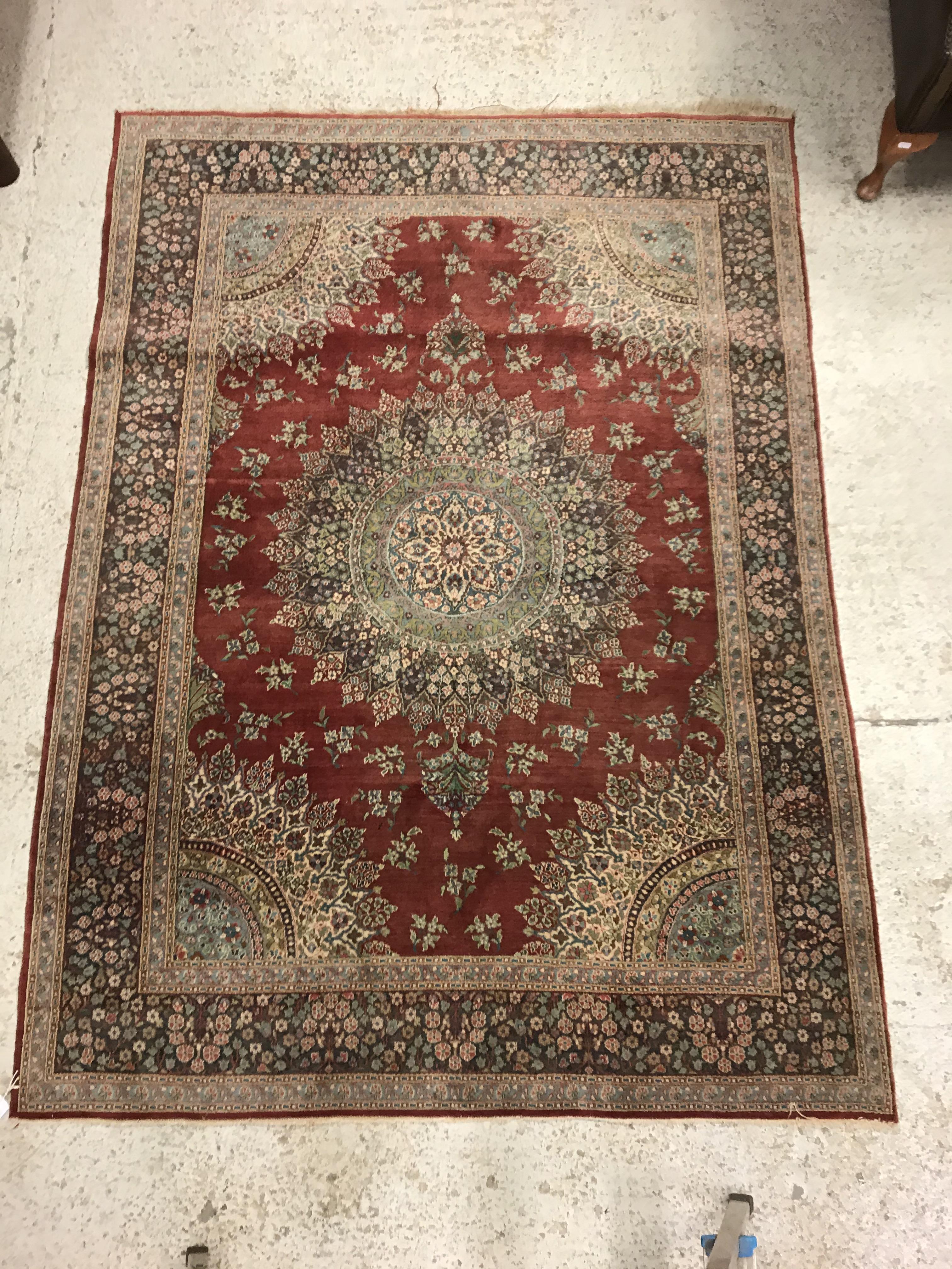 A pair of fine Oriental rugs, the central panels each set with floral decorated circular medallion