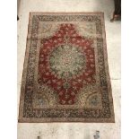 A pair of fine Oriental rugs, the central panels each set with floral decorated circular medallion