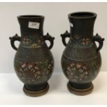 A pair of 19th Century Chinese bronze and cloisonné banded baluster shaped vases with kylin handles,