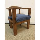 A modern Arts & Crafts style pine child's chair with yoke back and visible dovetails on