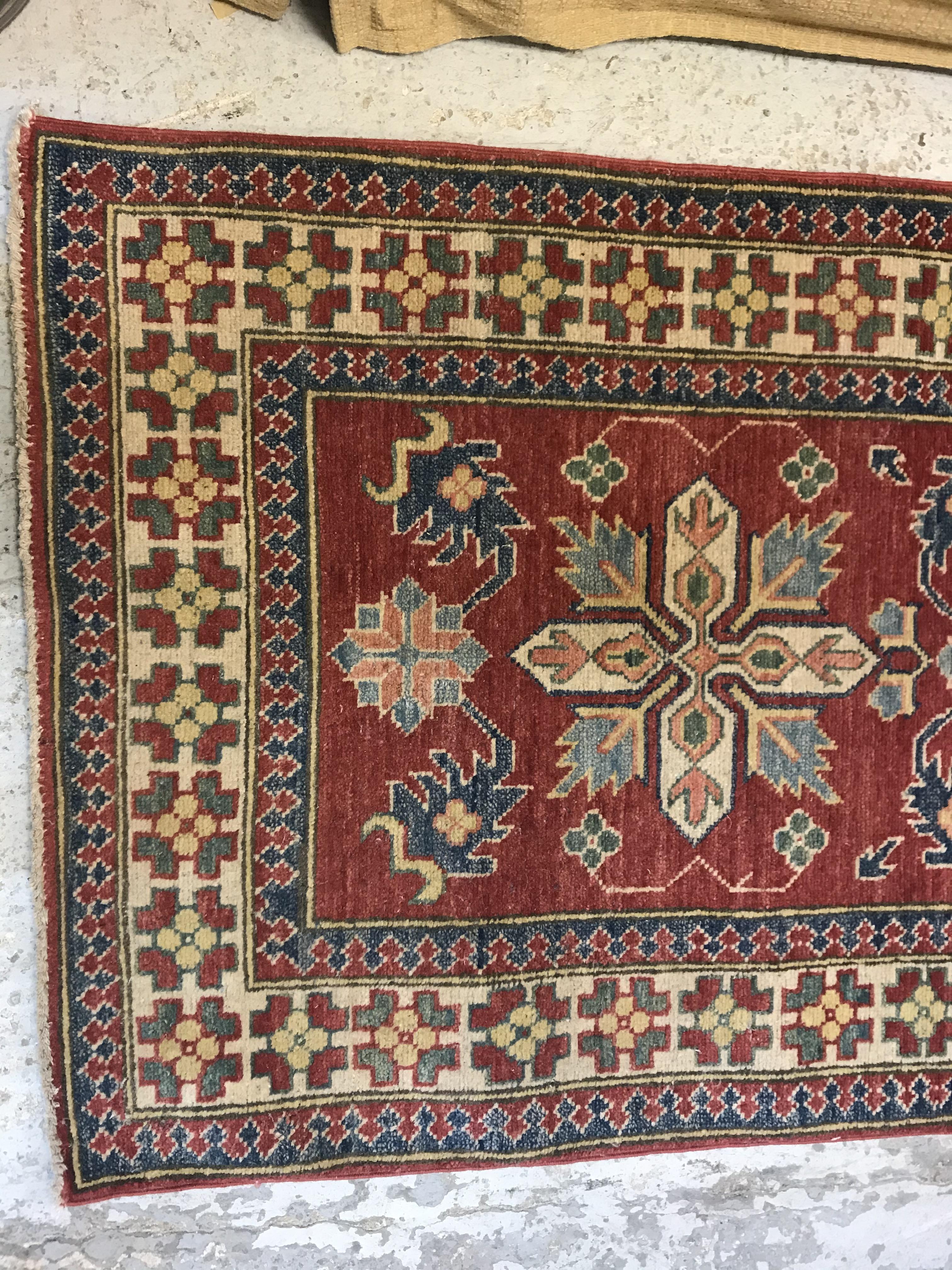 A modern Persian runner, the central panel set with repeating medallions on a red floral decorated - Image 2 of 13