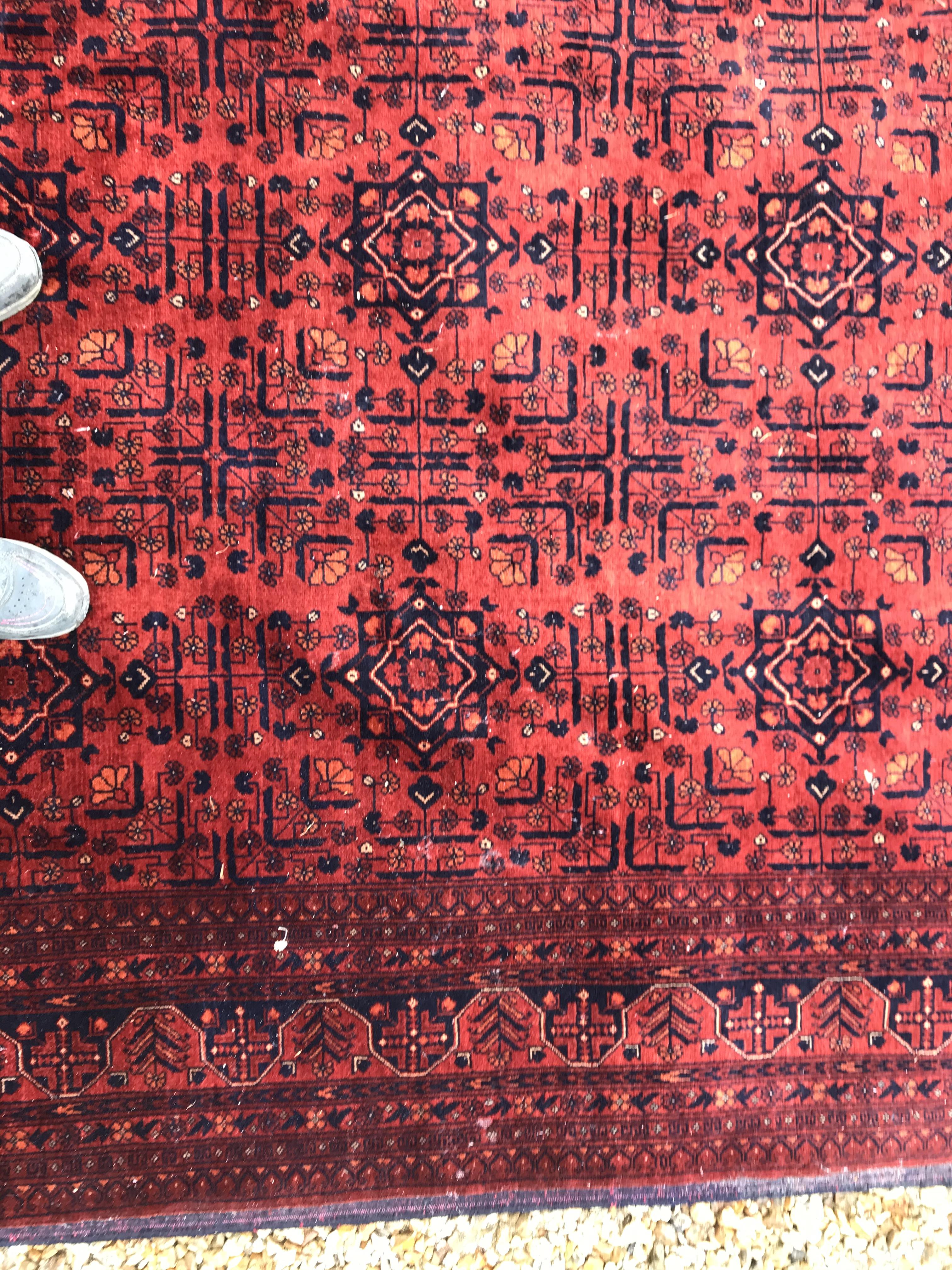 A Bokhara type carpet, the central panel set with repeating medallions on a dark red and black - Image 9 of 23