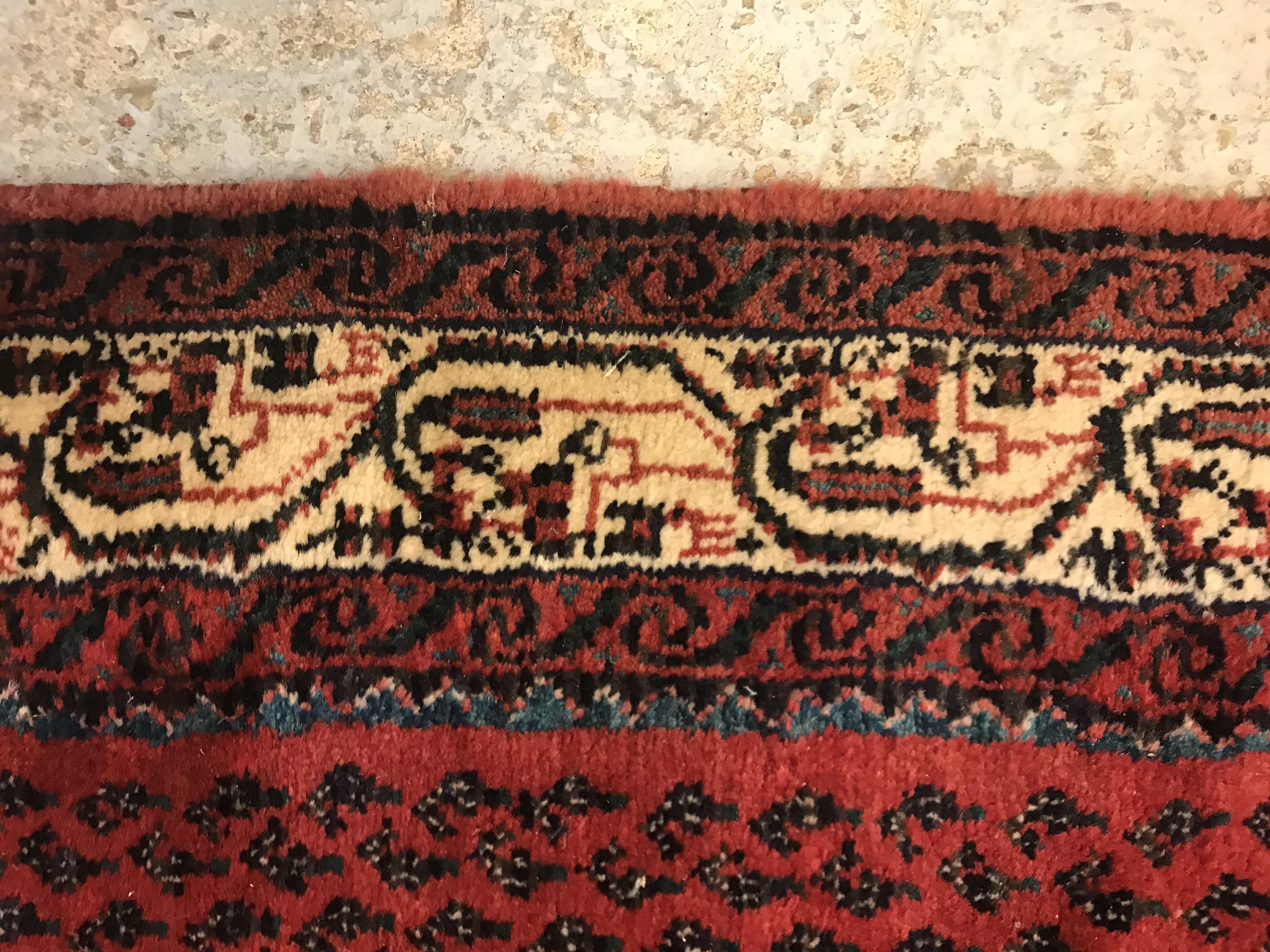 A modern Persian (Iran) runner, the red ground with repeating lozenge medallion with hook style - Image 17 of 23