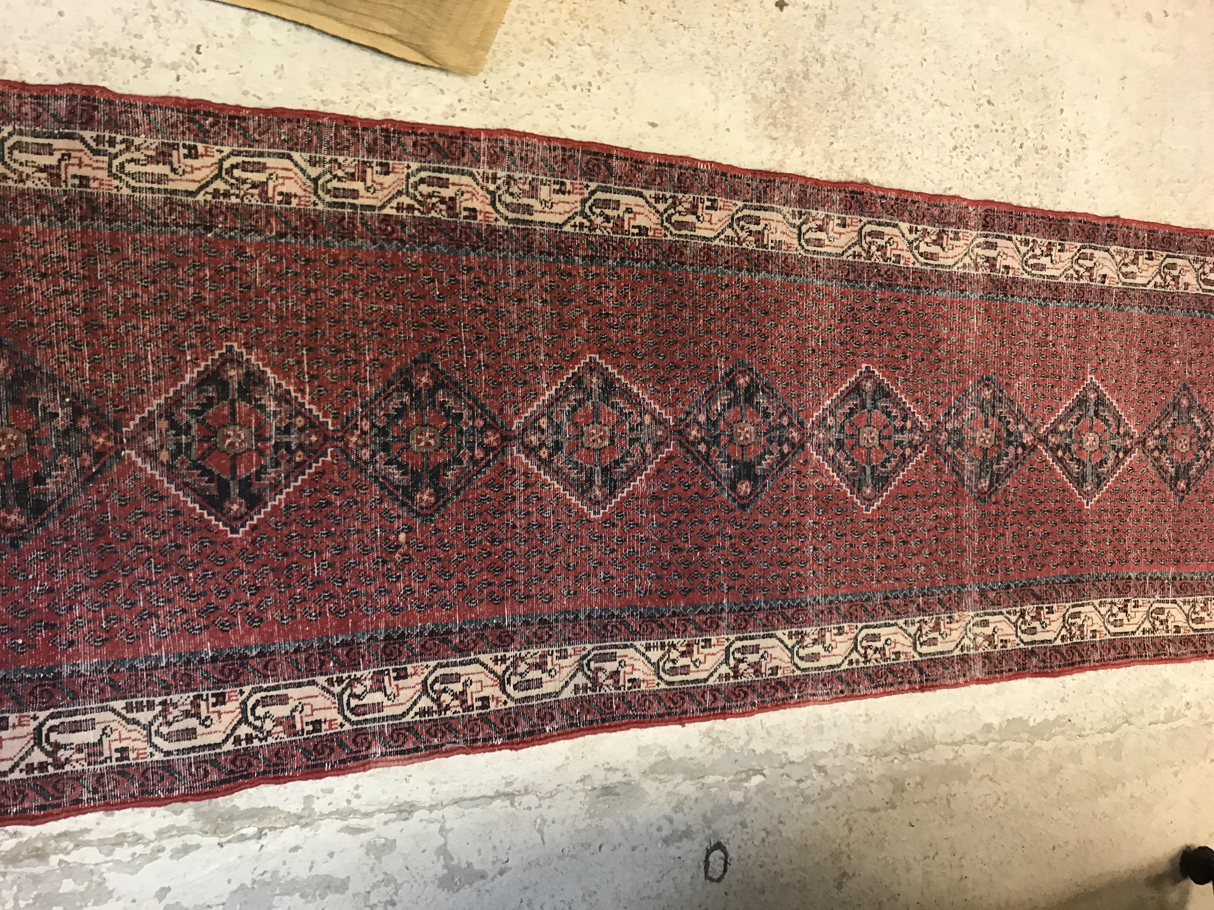 A modern Persian (Iran) runner, the red ground with repeating lozenge medallion with hook style - Image 22 of 23