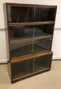 A Minty mahogany cased four section bookcase with sliding glass doors bearing label "Minty Limited