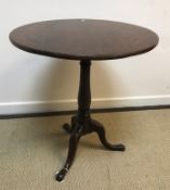 A 19th Century oak circular tilt-top tripod occasional table, 64.5 cm diameter x 73.5 cm high