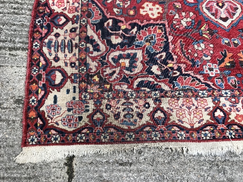 A Caucasian carpet, the central panel set with a flower head medallion on a red ground, with all - Image 8 of 10