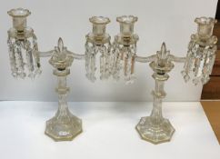 A pair of Continental etched and gilded octagonal glass table candelabra, the twin branch candle