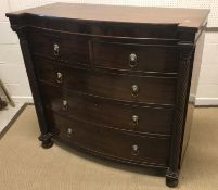 A Victorian mahogany bow fronted chest of two short over three long graduated drawers, flanked by