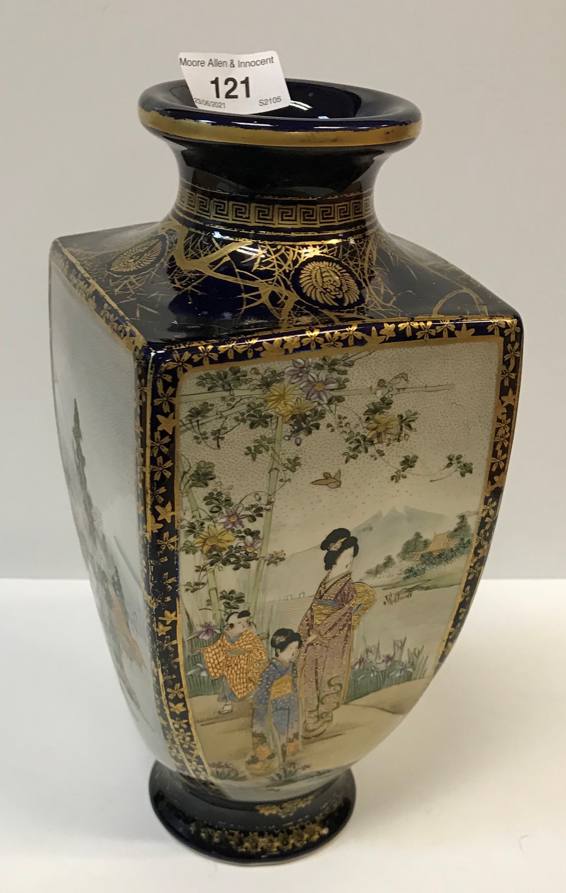 A Meiji Period Japanese Satsuma vase of tapering square form, decorated with panels of figures in