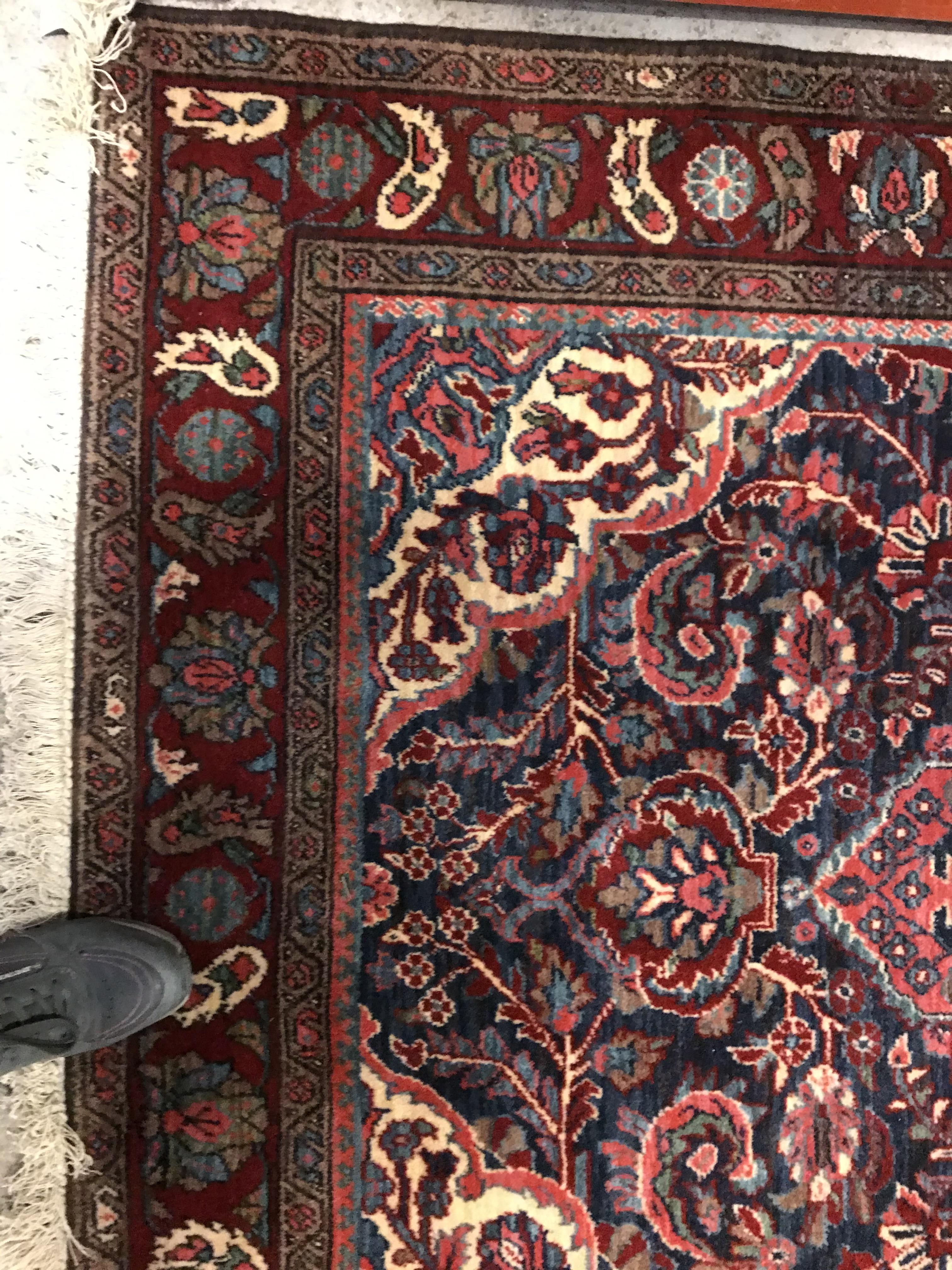 An Oriental carpet, the central panel set with foliate decorated medallion on a red and blue - Image 4 of 11