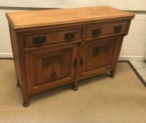 A Victorian carved oak sideboard or dresser, the plain top above two drawers and two cupboard