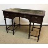 An Edwardian mahogany writing table with velvet writing surface over a central slim drawer flanked