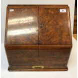 A Victorian walnut desk top stationery cabinet, the doors opening to reveal a fitted stationery