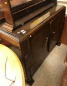A 1930's oak sideboard, oak plate rack, mahogany chest of two drawers over two cupboard doors,