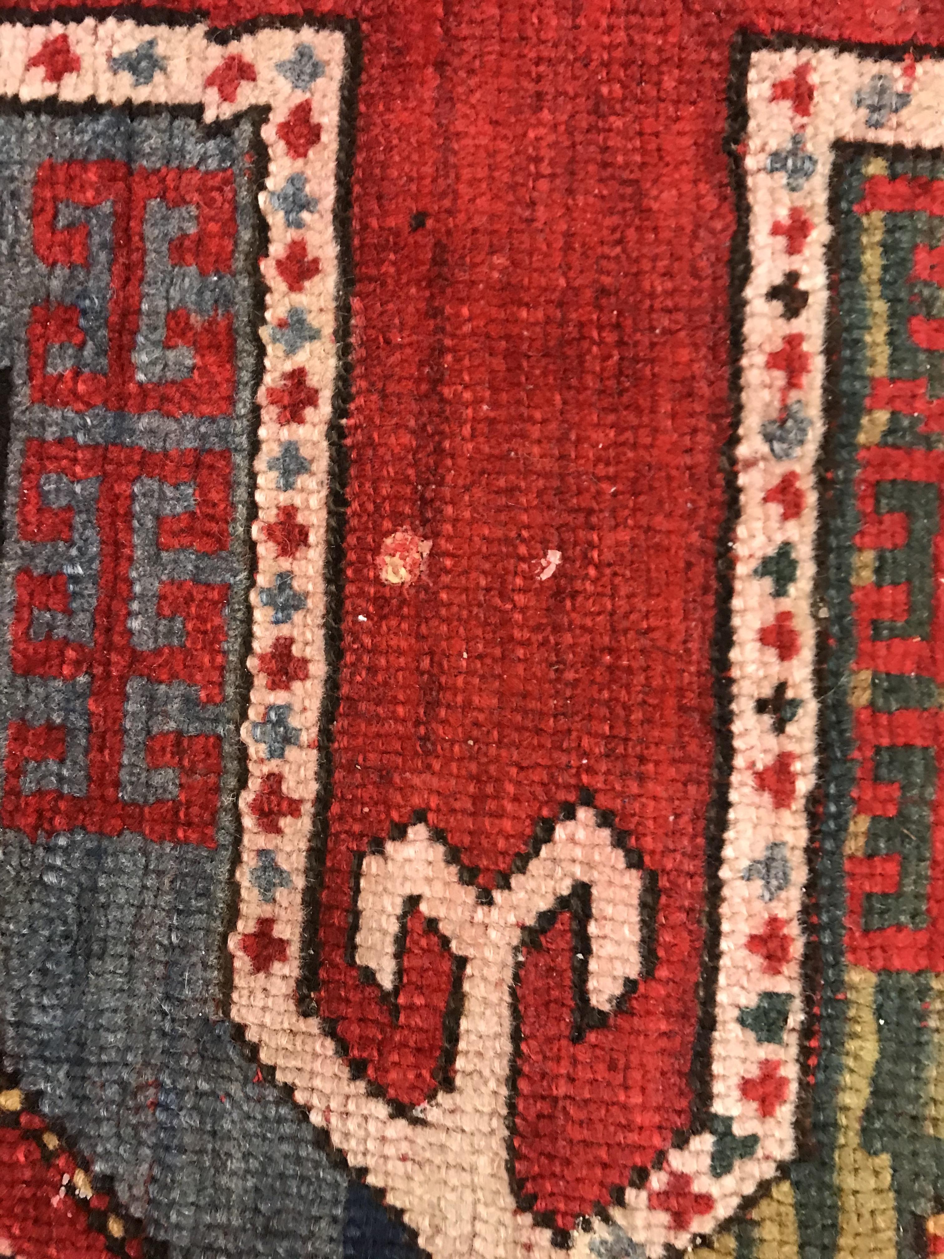 A Kasak runner, the central panel set with three repeating square medallions on a red ground - Image 6 of 10