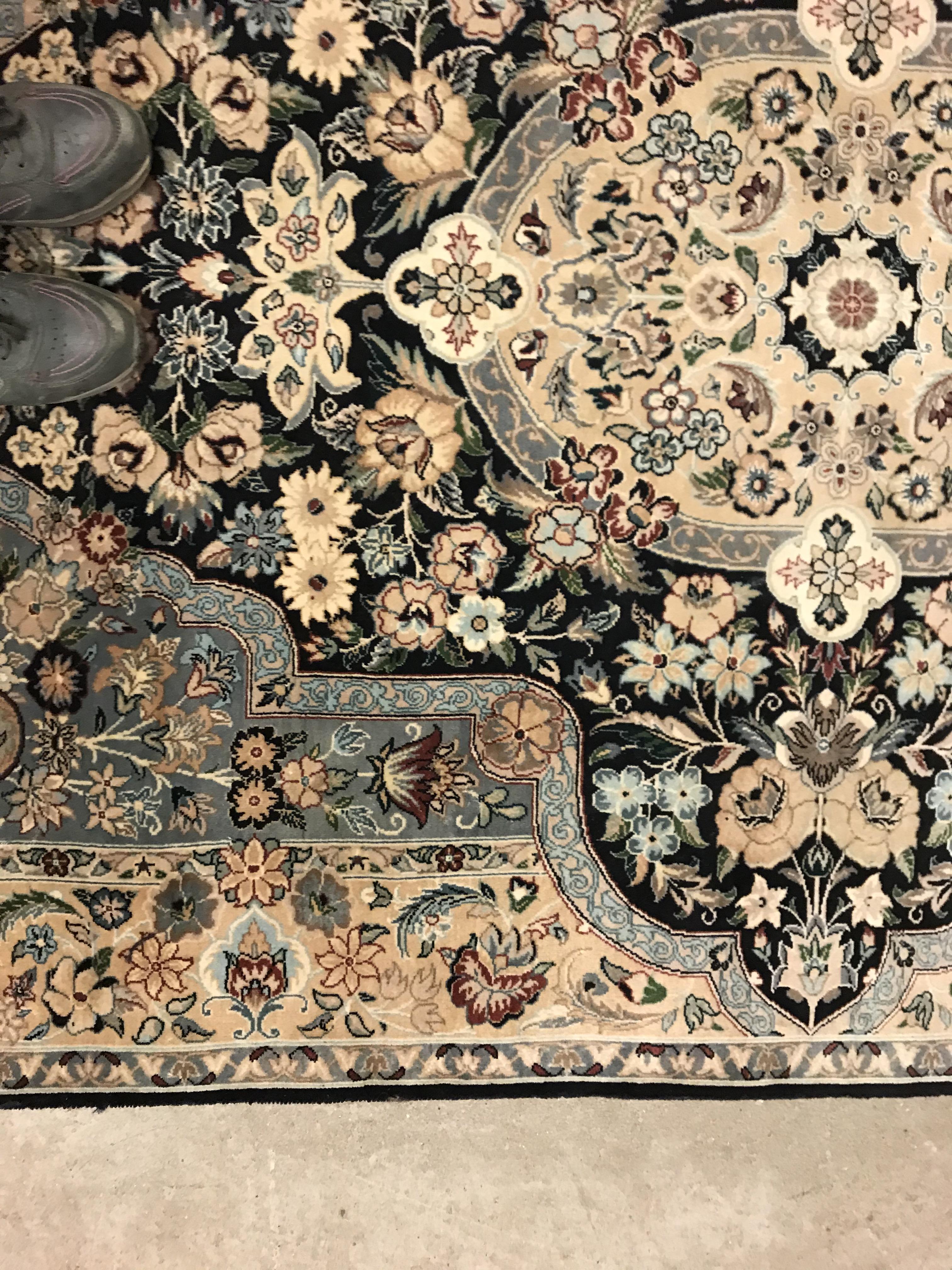 A Persian rug, the central panel set with floral decorated oval medallion on a dark blue and pale - Image 4 of 10