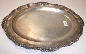 A Regency silver oval dish, the plain centre field within a border bearing armorials and with