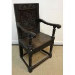 A 17th Century oak Wainscott type chair, the lunette carved top rail over a foliate medallion