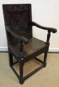 A 17th Century oak Wainscott type chair, the lunette carved top rail over a foliate medallion