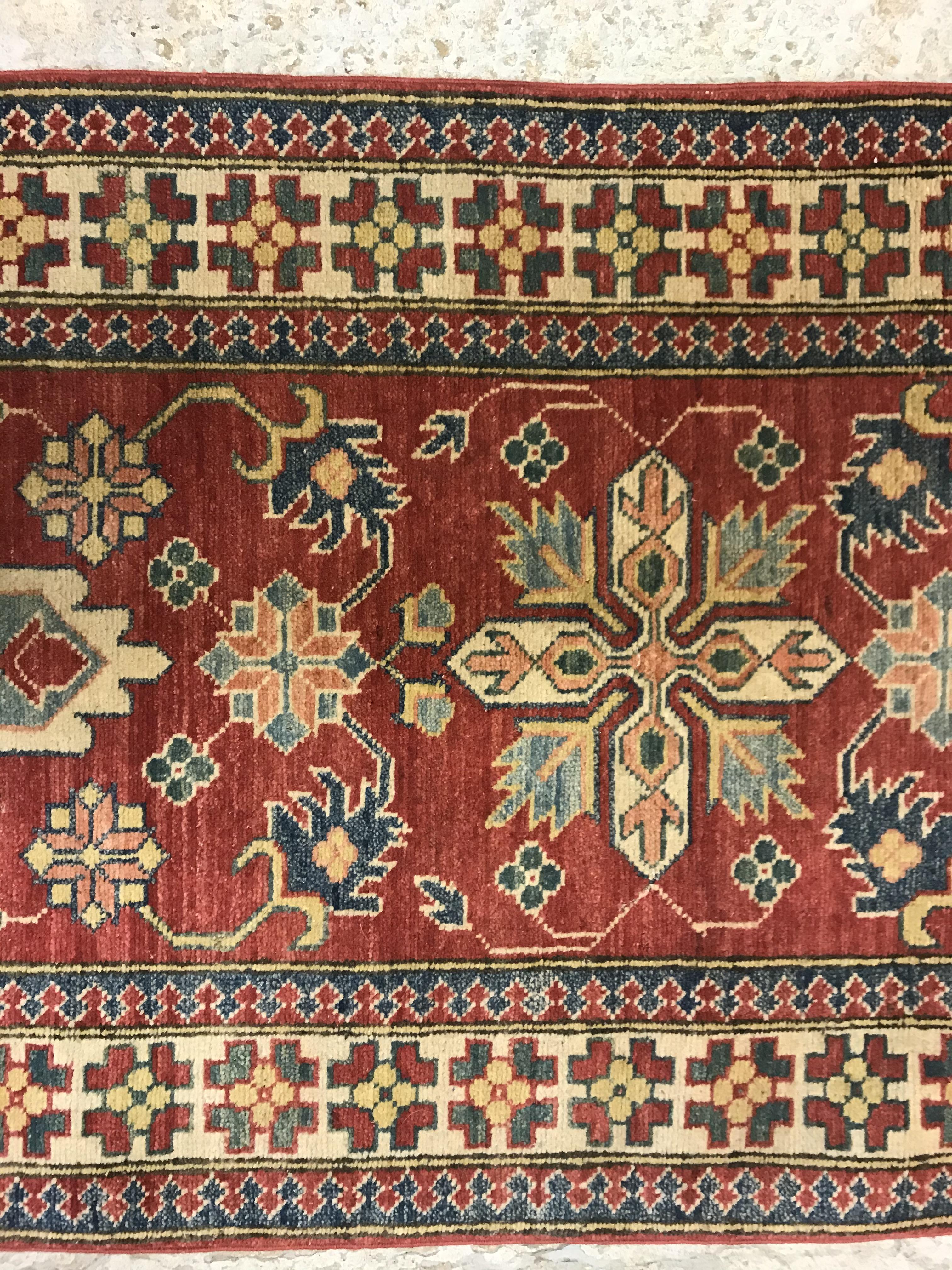 A modern Persian runner, the central panel set with repeating medallions on a red floral decorated - Image 6 of 13