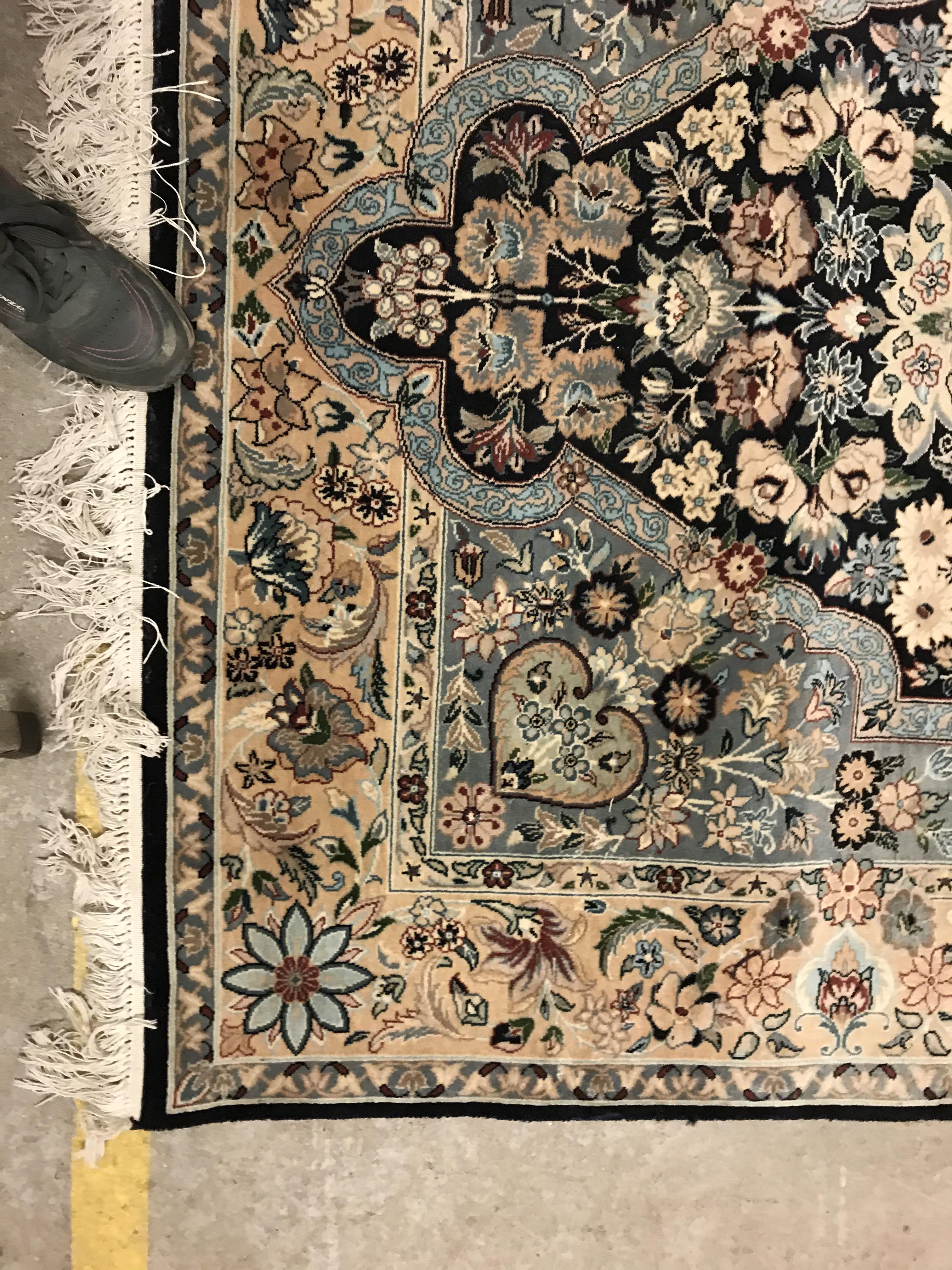 A Persian rug, the central panel set with floral decorated oval medallion on a dark blue and pale - Image 3 of 10