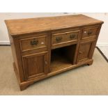 An oak dresser in the Victorian manner, the top with moulded edge above three drawers and dog kennel