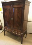 A 19th Century mahogany and yew wood cupboard, the moulded cornice above two fielded panelled