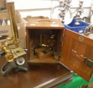 An early 20th Century lacquered brass and anodised monocular microscope, un-named, together with