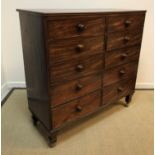 A Victorian mahogany chest, the top with applied moulded edge above two banks of five drawers with