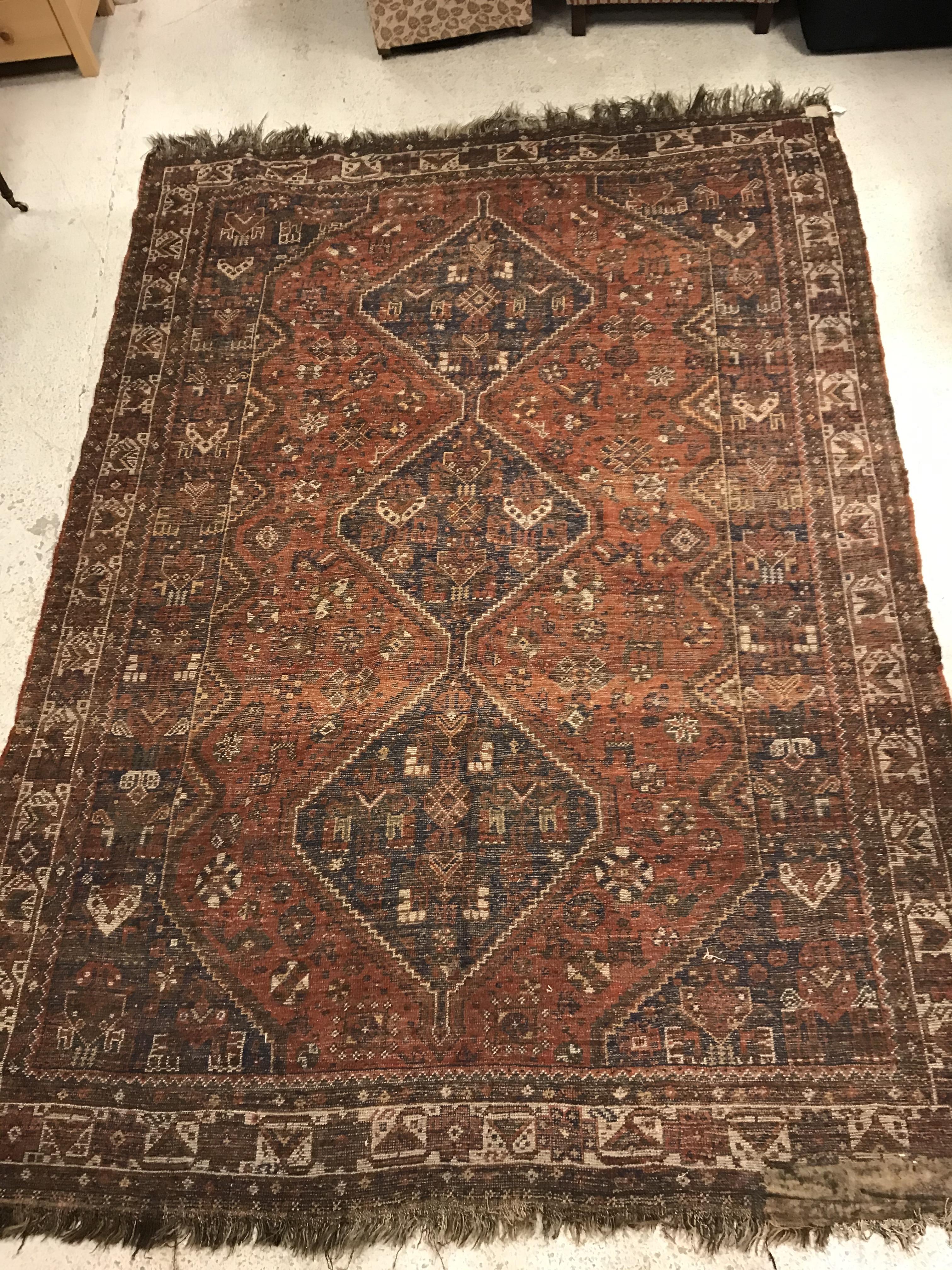 A Shiraz carpet, the central panel set with three joined diamond shaped medallions on a red and blue - Image 15 of 17