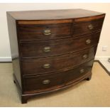A Regency mahogany bow fronted chest, the cross-banded top over a satinwood banded frieze and two
