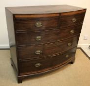 A Regency mahogany bow fronted chest, the cross-banded top over a satinwood banded frieze and two