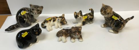 A collection of eight Winstanley pottery glass eyed Cat figures, various colours, poses and sizes