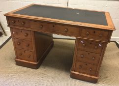 A Victorian oak double pedestal desk, the top with insert writing surface within a moulded edge,