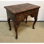 An 18th Century Scottish laburnum lowboy, the parquetry work top cross-banded and with moulded