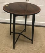 A brass framed occasional table with tooled and gilded leather insert circular top on a faux