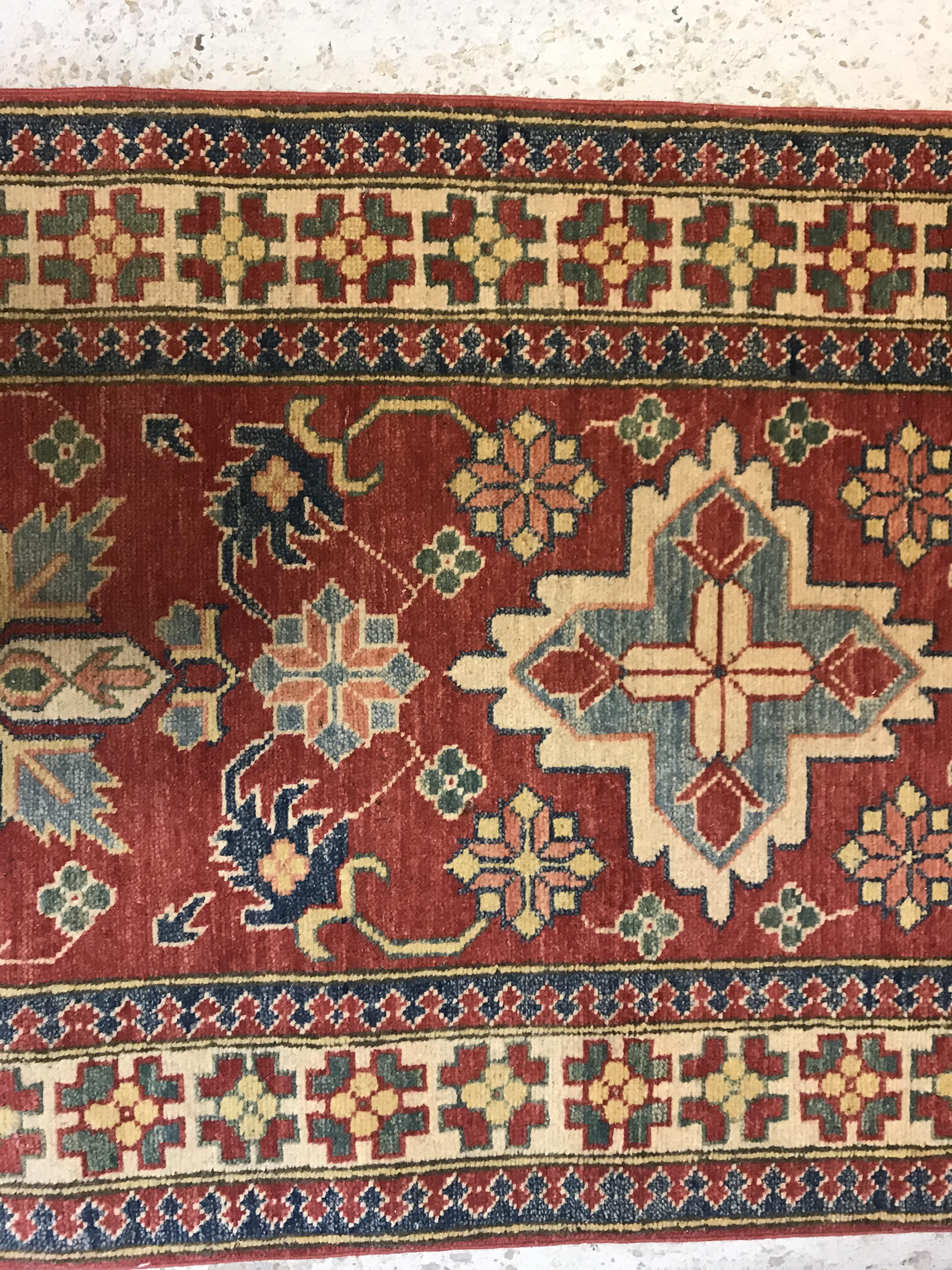 A modern Persian runner, the central panel set with repeating medallions on a red floral decorated - Image 3 of 13