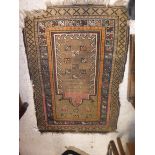 An Ushak prayer rug, the central panel on a green ground, within a stepped orange, blue and mushroom