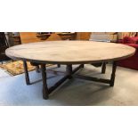 An Arts & Crafts style pine centre table, the cross-banded circular top on seven (of eight) turned