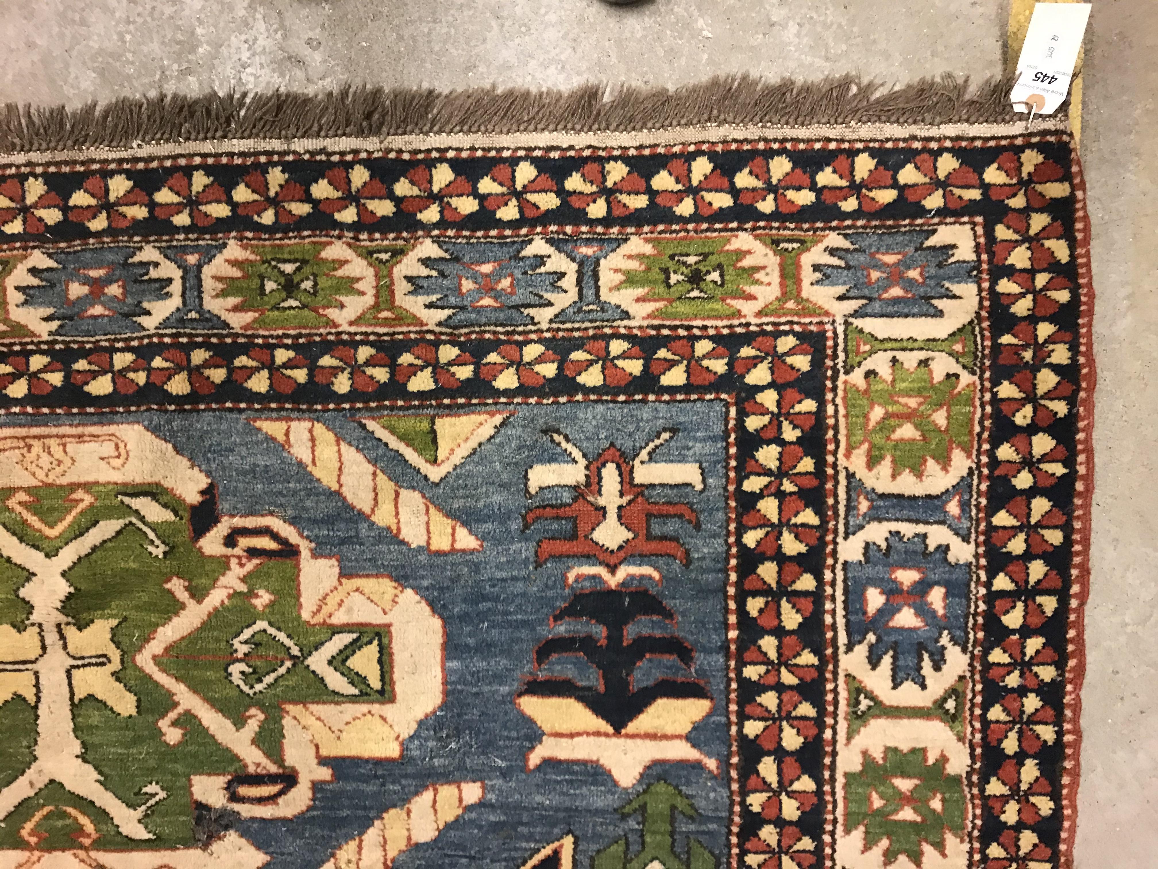 A Caucasian rug, the central panel set with three repeating medallions on a pale blue ground, within - Image 2 of 33