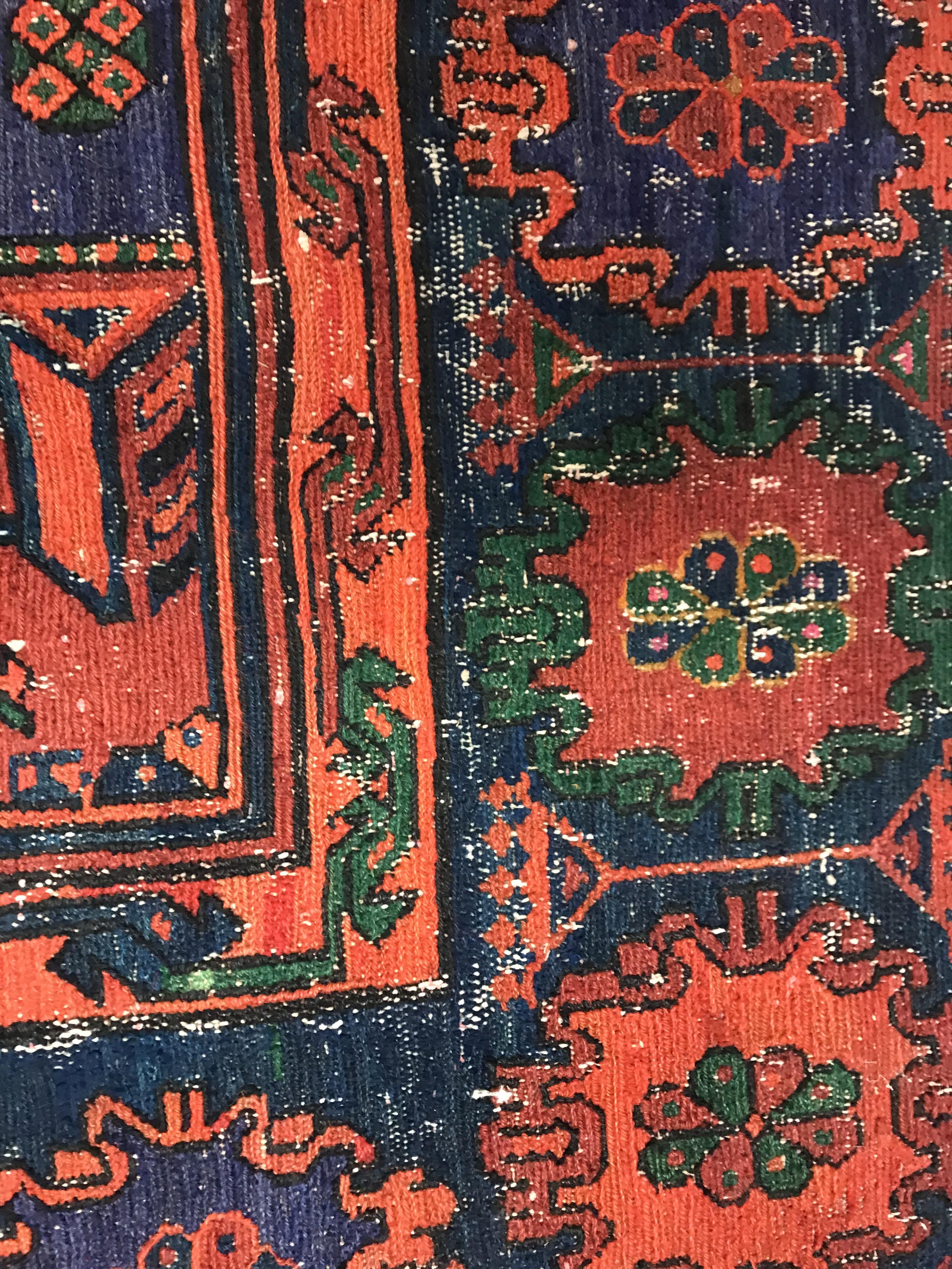 A Persian rug with three repeating lozenge medallions on a red and blue ground, within a blue, red - Image 10 of 20