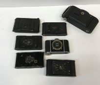 A collection of eight various cameras including a Voigtländer 6M bellows camera, Kodak VP